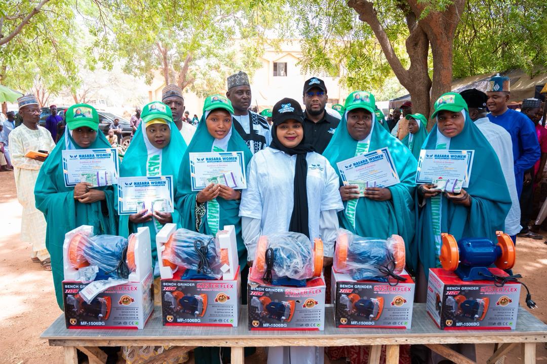 Women receiving certificates and livelihood equipment through a skills programme